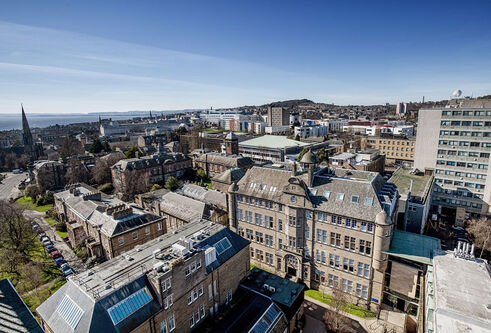 Aerial view of the city campus with blue skies and view of the Old Medical School and Geddes Quadrangle