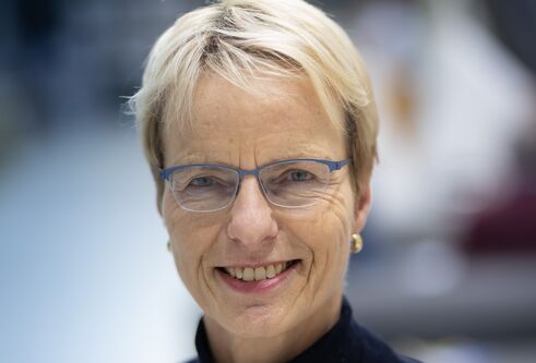 Picture of woman with glasses smiling at camera