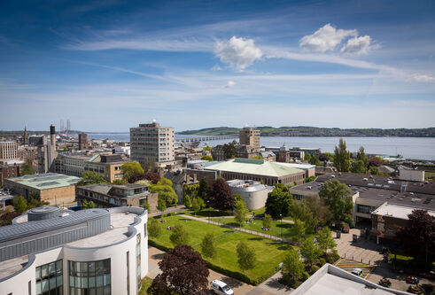 Campus green showing several of the city campus buildings