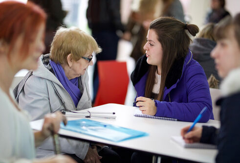 Social work student speaking to elderly person