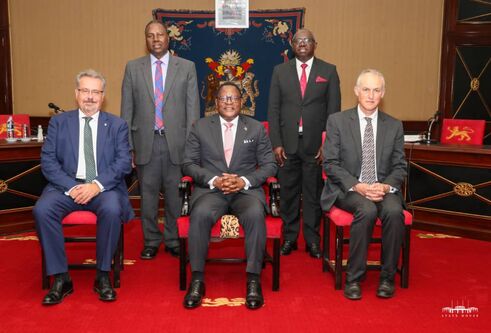 Professors Iain Gillespie and Paul van Gardingen, sit with His Excellency, Dr Lazarus McCarthy Chakwera, President of Malawi