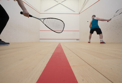 Two people play squash on the courts at Institute of Sport and Exercise