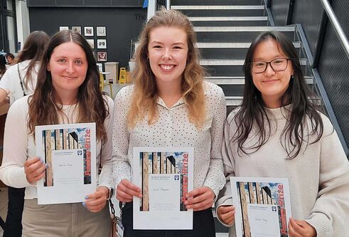 Three School of Life Sciences Summer School Poster winners holding their awards