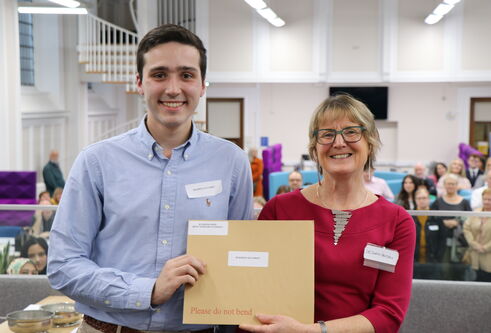 Dr Sarah Hendry handing out Dundee Law School award to a student