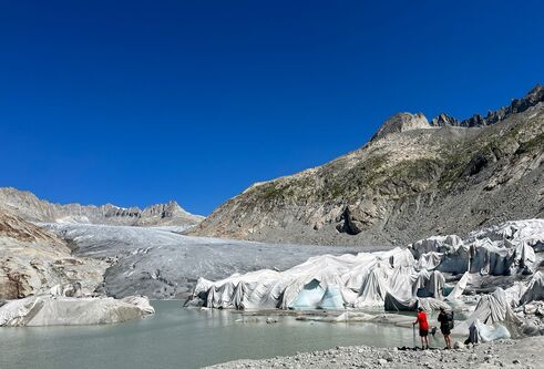 Dr Simon Cook  observing the front of a rapidly retreating glacier, Rhone, Switzerland, 2022