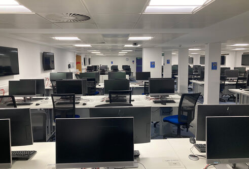 IT Suite in Tower Basement showing rows of desks with computer screens