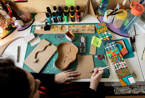 A DJCAD student working on her Degree Show project in the studio.
