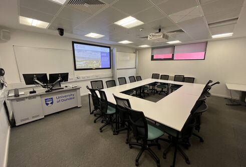 Dalhousie1G15 - white table set in a square with tv screen on the wall