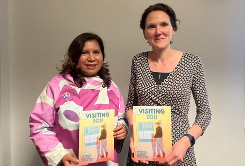 Mayra Crowe and Dr Pauline Austin, coordinators of the project, holding the Visiting ICU comic