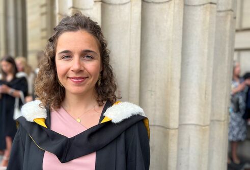 Maitane on graduatoin day outside caird hall wearing her graduation robe