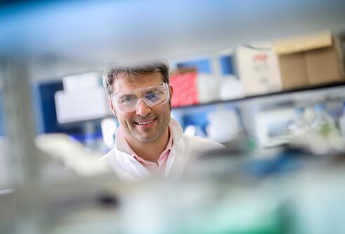Alessio Ciulli wearing a lab coat in the laboratory 