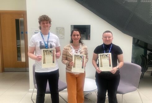 Poster prize winners holding their certificates