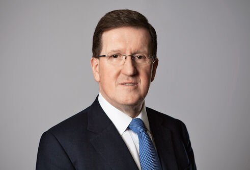Lord Robertson in black suit and blue tie