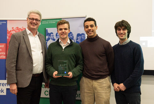 Professor Blair Grubb stands with the Cognicall team and their award