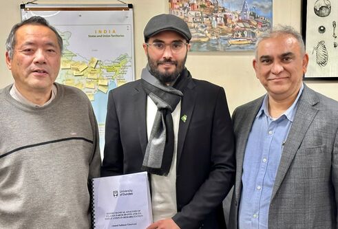 Ahmad Ghazwani and team standing with his PhD paper