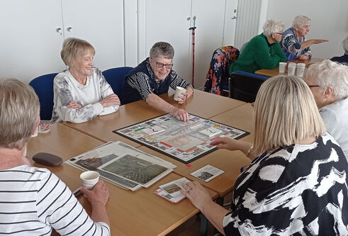Young at Heart group sitting at a table playing a board game