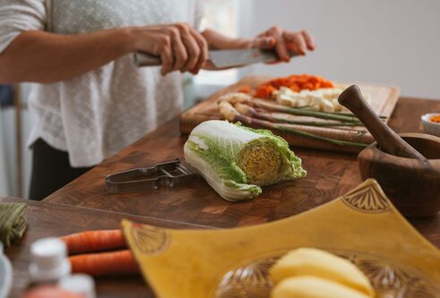 person chopping vegetables