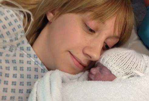 A young mum holding her new born daughter