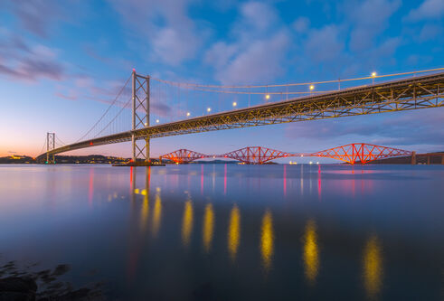 The Forth Road bridge and rail bridge at Edinburgh during sunset