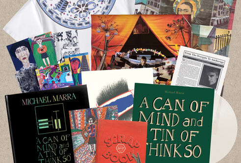 The contents of the boxset, including book, t-shirt and various notes and artwork
