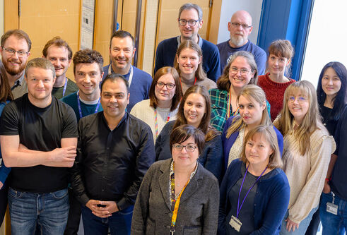 A group of people stood together smiling