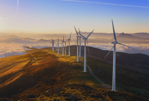 Pictures of a series of wind turbines on a hill at sunrise