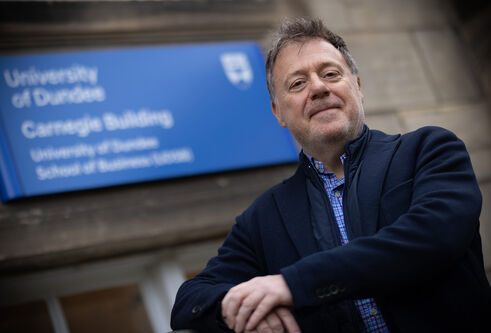 Gordon Craig standing outside the School of Business building