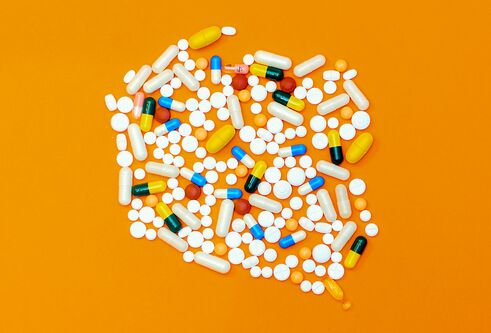 A mixture of medications on an orange background