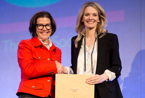 Emma Johnson (on right) receives an award from Early Career Investigator Award by the British Association for Lung Research and British Thoracic Society