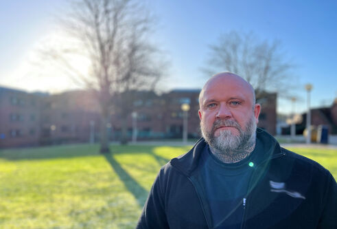David Lyon, wearing a black fleece in the quadrangle of the School of Health Sciences, Kirkcaldy.
