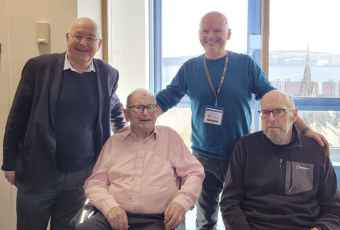 Four people, two stood and two seated.