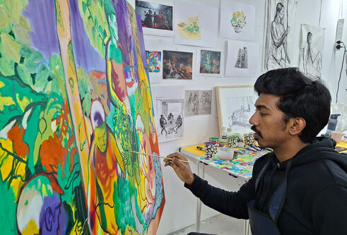 Ujwal adding final touches to his painting in a DJCAD studio