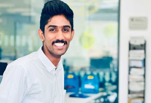 Gokul Raghunathan wearing a white shirt and smiling.