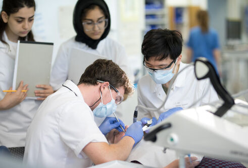 Dentistry students wearing protective masks and glasses performing clinical skills at Dundee.