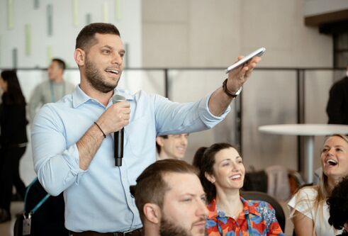 man holding microphone and gesturing