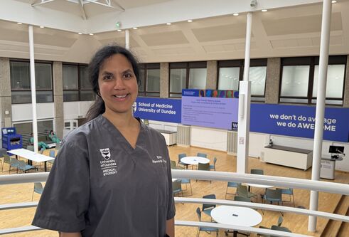 Anna Anandarajah in medical scrubs within the School of Medicine, Ninewells. 