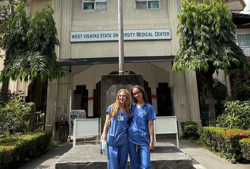 Two medical students stand outside a medical centre in Phillipines