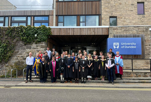 Graduates from HSSL standing in front of Tower Building