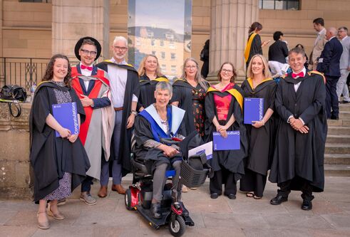 Graduates posing outside the Caird Hall