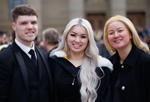 Three graduates outside Caird Hall
