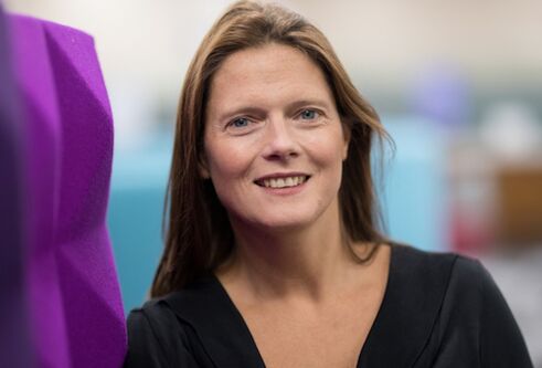 Dr Sarah Martins da Silva looking at camera in headshot pose