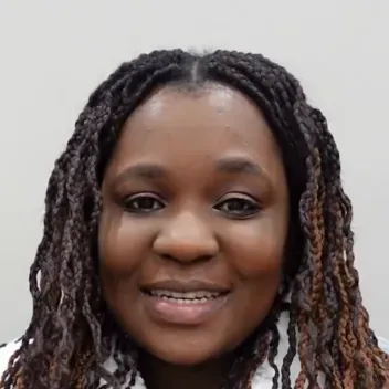 female student in front of grey background