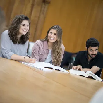 Students sitting together in a class smiling