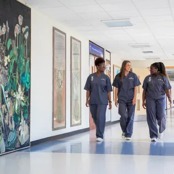 Dundee medical students with scrubs on walking in corridor at Ninewells hospital