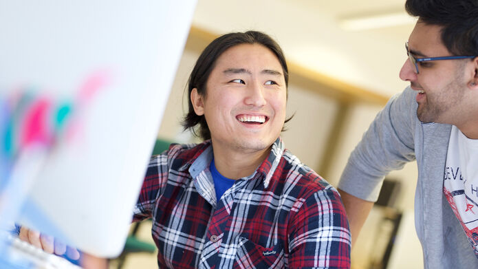 Man smiling at computer