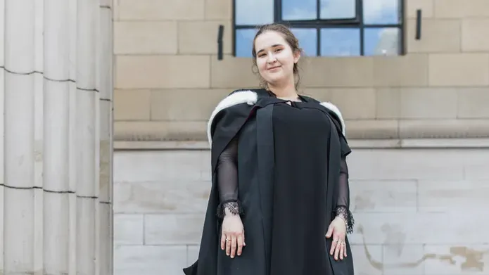 Aleksandra Mergo in a graduation gown outside Caird Hall