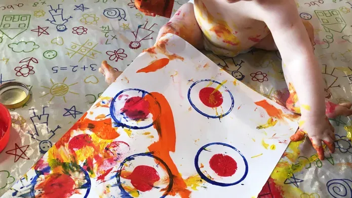 Baby playing with paints