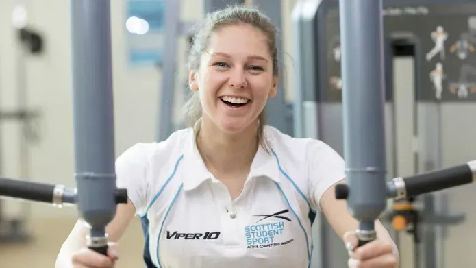 Woman in exercise clothes using a weights machine