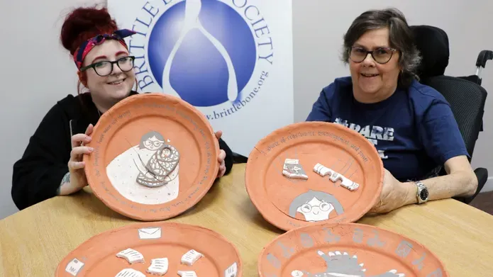 Nicole McLaughlin holding the plates she designed