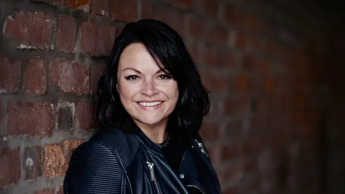Caroline McKenna standing by a wall